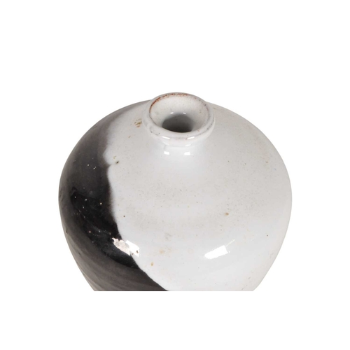 24 - Late 20th century studio pottery drip glaze vase. Of ovoid form with a black and white two tone drip... 
