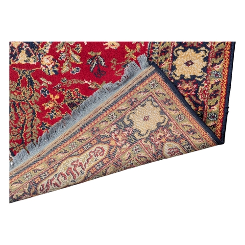 A 20th century 'Lahore' vintage machine made wool rug, the red ground ...