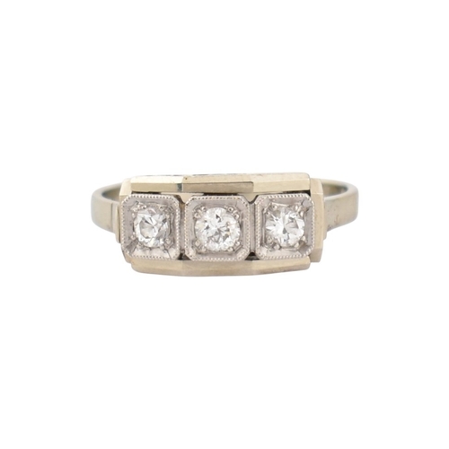 61 - An Art Deco 14ct white gold three stone diamond ring. The ring set with three diamonds within a face... 