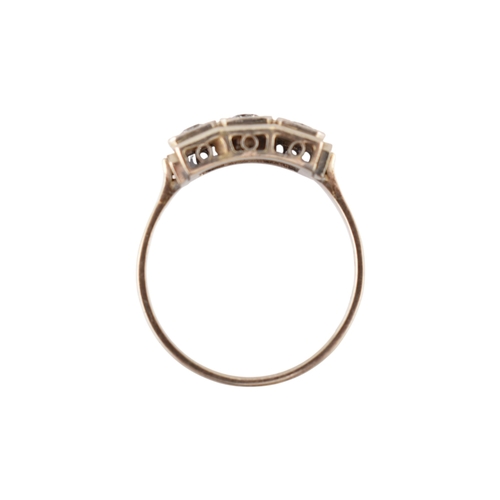 61 - An Art Deco 14ct white gold three stone diamond ring. The ring set with three diamonds within a face... 