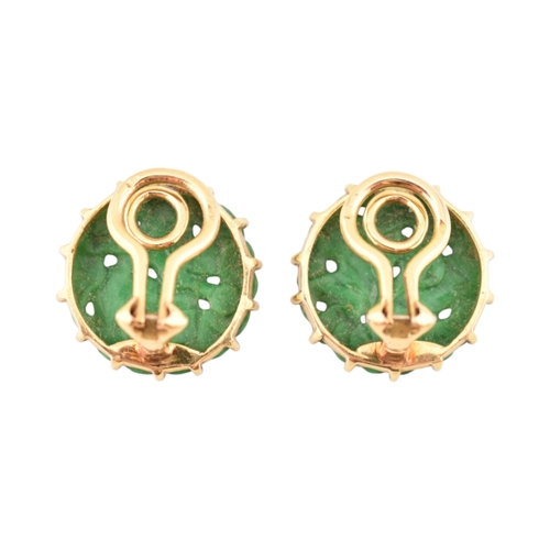 68 - A pair of French 18ct gold and carved jade panel ear clips. The earrings with pierced and carved rou... 