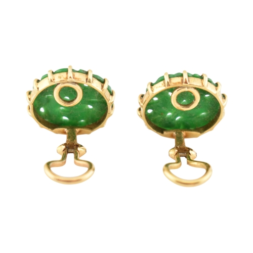 68 - A pair of French 18ct gold and carved jade panel ear clips. The earrings with pierced and carved rou... 