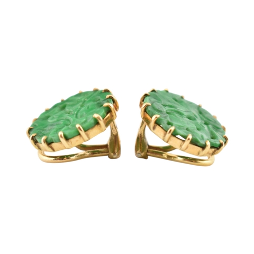 68 - A pair of French 18ct gold and carved jade panel ear clips. The earrings with pierced and carved rou... 