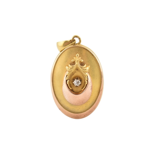 69 - A gold and diamond set locket pendant. The pendant set with a rose cut diamond framed by foliates an... 