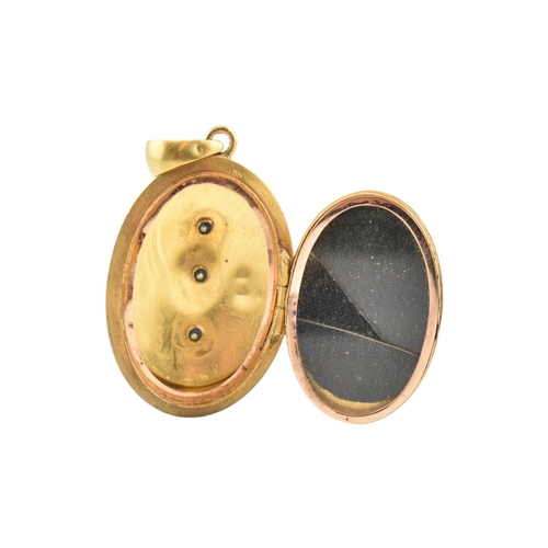 69 - A gold and diamond set locket pendant. The pendant set with a rose cut diamond framed by foliates an... 