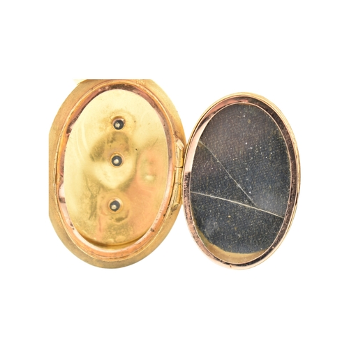 69 - A gold and diamond set locket pendant. The pendant set with a rose cut diamond framed by foliates an... 