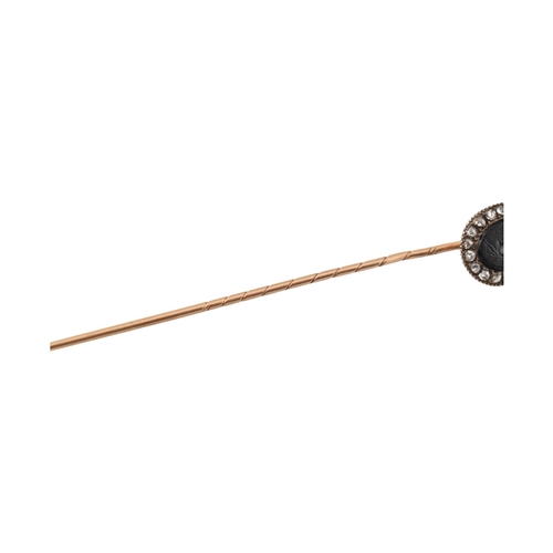 70 - A 19th century gold intaglio and diamond stickpin. The stickpin is surmounted by an intaglio of a he... 
