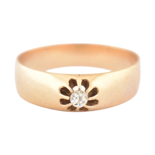 72 - An antique gold and diamond solitaire ring. The ring with a claw mounted old cut diamond to a wide b... 