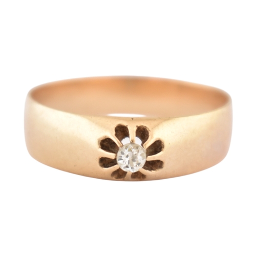 72 - An antique gold and diamond solitaire ring. The ring with a claw mounted old cut diamond to a wide b... 