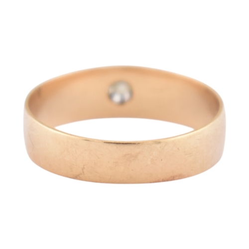 72 - An antique gold and diamond solitaire ring. The ring with a claw mounted old cut diamond to a wide b... 