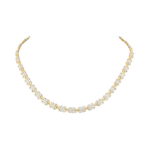 73 - An 18ct gold yellow and white diamond flower cluster necklace. The necklace with thirty-eight cluste... 