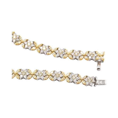 73 - An 18ct gold yellow and white diamond flower cluster necklace. The necklace with thirty-eight cluste... 