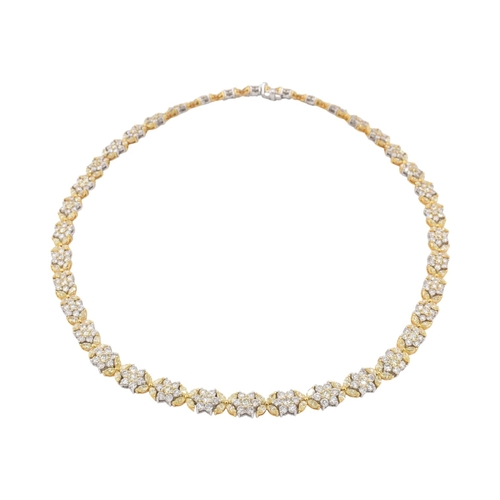73 - An 18ct gold yellow and white diamond flower cluster necklace. The necklace with thirty-eight cluste... 