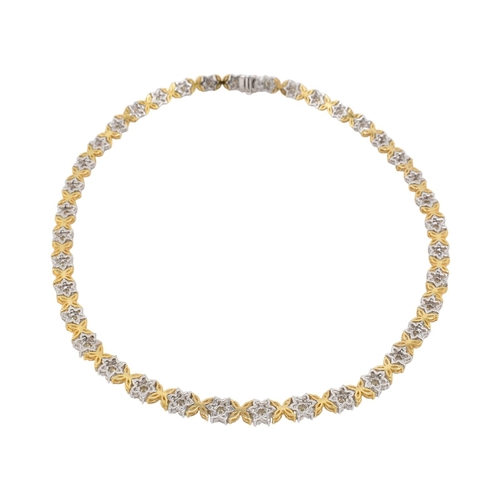73 - An 18ct gold yellow and white diamond flower cluster necklace. The necklace with thirty-eight cluste... 