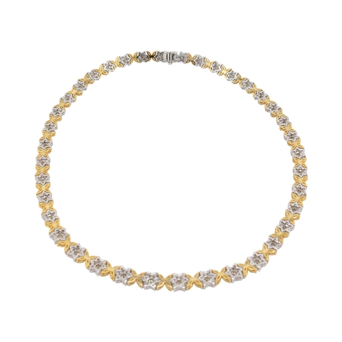73 - An 18ct gold yellow and white diamond flower cluster necklace. The necklace with thirty-eight cluste... 