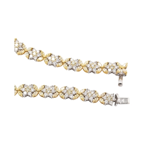 73 - An 18ct gold yellow and white diamond flower cluster necklace. The necklace with thirty-eight cluste... 