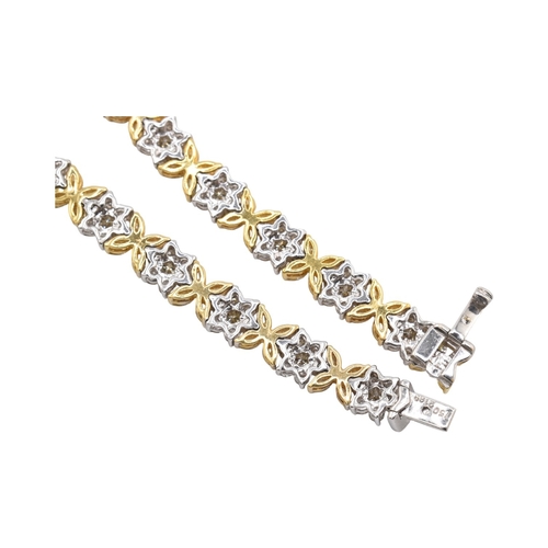 73 - An 18ct gold yellow and white diamond flower cluster necklace. The necklace with thirty-eight cluste... 