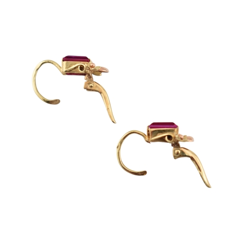 77 - A pair of 14ct gold and synthetic ruby pendant earrings. The earrings set with emerald cut synthetic... 