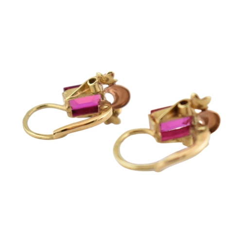 77 - A pair of 14ct gold and synthetic ruby pendant earrings. The earrings set with emerald cut synthetic... 