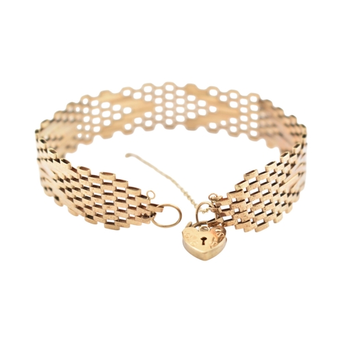 79 - A hallmarked 9ct gold fancy link bracelet with heart clasp padlock. Hallmarked London. Weight 8.3g. ... 