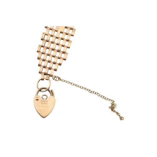 79 - A hallmarked 9ct gold fancy link bracelet with heart clasp padlock. Hallmarked London. Weight 8.3g. ... 