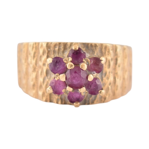 87 - A hallmarked 9ct gold and ruby cluster ring. Hallmarked London, sponsors mark G&T.J. Weight 4.6g... 