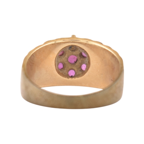 87 - A hallmarked 9ct gold and ruby cluster ring. Hallmarked London, sponsors mark G&T.J. Weight 4.6g... 