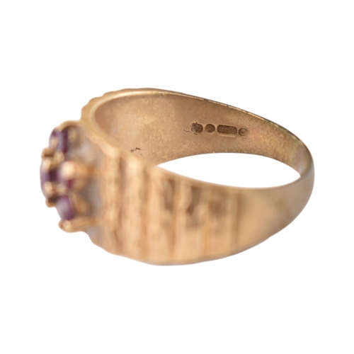 87 - A hallmarked 9ct gold and ruby cluster ring. Hallmarked London, sponsors mark G&T.J. Weight 4.6g... 