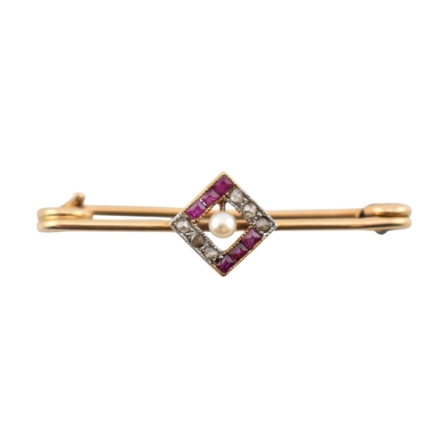 89 - A cased early 20th century Art Deco 15ct gold ruby and diamond brooch pin. The brooch with a central... 
