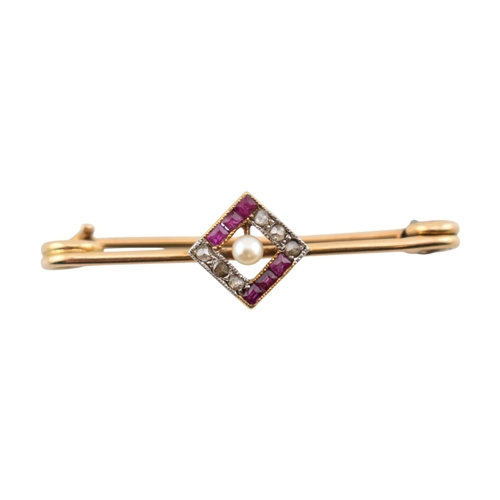 89 - A cased early 20th century Art Deco 15ct gold ruby and diamond brooch pin. The brooch with a central... 