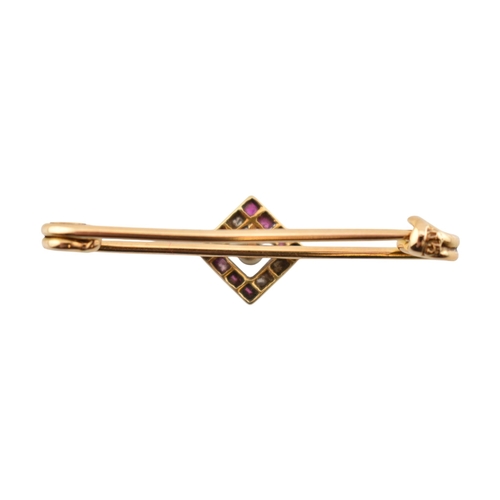 89 - A cased early 20th century Art Deco 15ct gold ruby and diamond brooch pin. The brooch with a central... 
