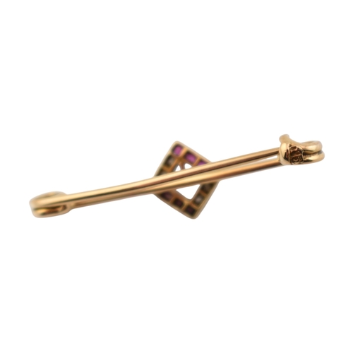 89 - A cased early 20th century Art Deco 15ct gold ruby and diamond brooch pin. The brooch with a central... 
