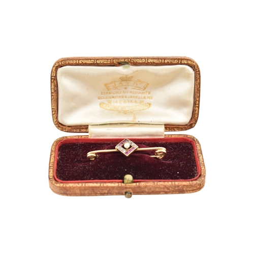 89 - A cased early 20th century Art Deco 15ct gold ruby and diamond brooch pin. The brooch with a central... 