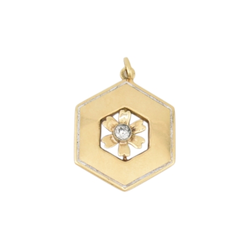 91 - A gold diamond enamel flower pendant. The hexagonal pendant with a central flower motif set with an ... 