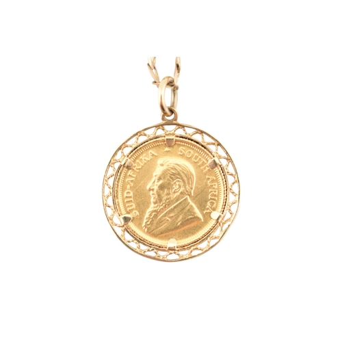 94 - A South African gold one-tenth 1/10 oz Krugerrand 1984 coin inset to a pendant mount and strung upon... 