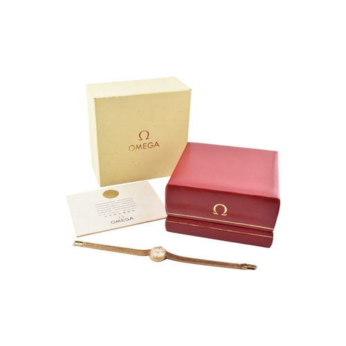 96 - A hallmarked 9ct gold Omega wristwatch and strap. The silvered dial with baton markers. Set with ori... 