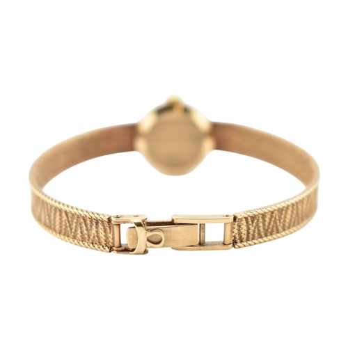 96 - A hallmarked 9ct gold Omega wristwatch and strap. The silvered dial with baton markers. Set with ori... 