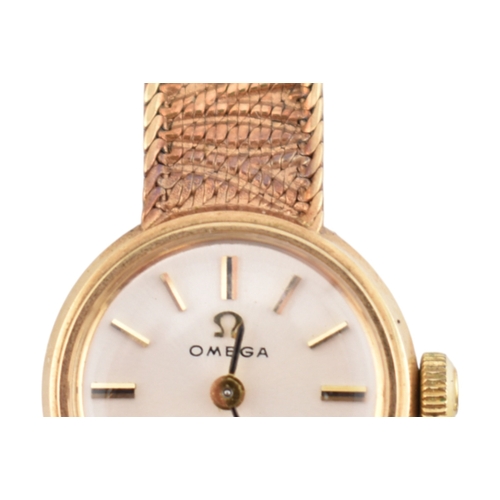 96 - A hallmarked 9ct gold Omega wristwatch and strap. The silvered dial with baton markers. Set with ori... 