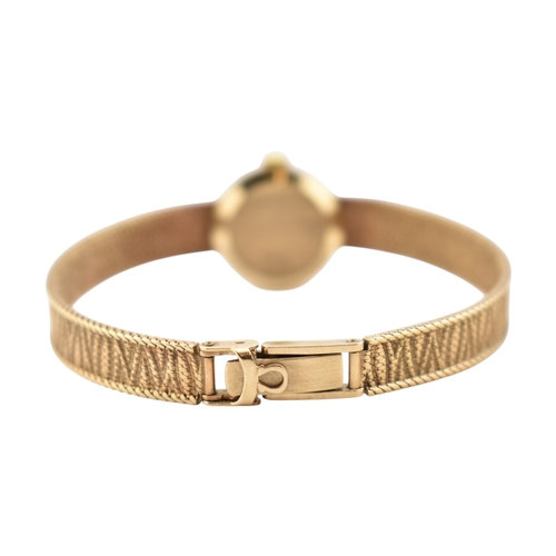 96 - A hallmarked 9ct gold Omega wristwatch and strap. The silvered dial with baton markers. Set with ori... 