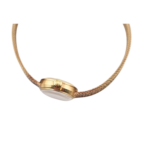 96 - A hallmarked 9ct gold Omega wristwatch and strap. The silvered dial with baton markers. Set with ori... 