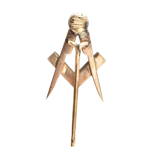 98 - A 19th century gold and paste Masonic stickpin. The stickpin topped with the Masonic square and comp... 