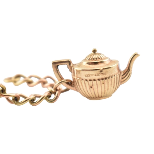 99 - A 9ct gold charm bracelet. The bracelet strung with multiple charms to include a hallmarked bell, a ... 