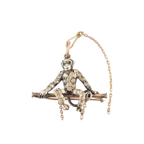 101 - A 1920s silver and gold pin paste set monkey pendant brooch pin. The brooch with a monkey sat upon a... 