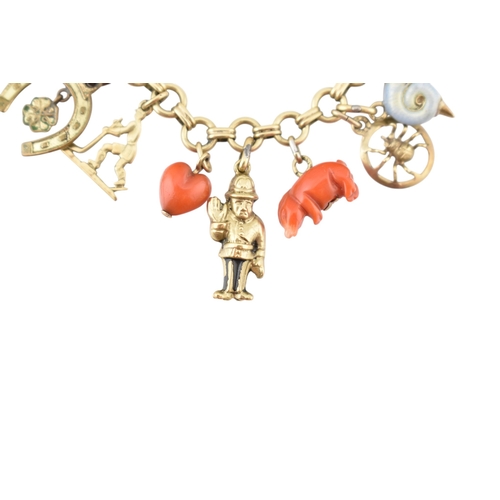 102 - Two Czechoslovakian 14ct gold charm bracelets. The bracelets strung with assorted charms, including ... 