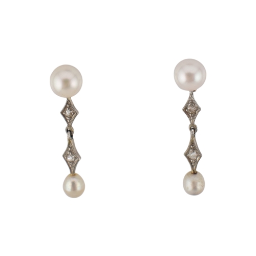 103 - A pair of pearl and diamond pendant earrings. The earrings marked of 18K to posts. Fasteners tests s... 