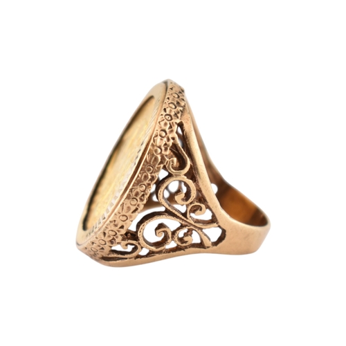 104 - A 9ct gold sovereign ring. The ring set with a 1962 full sovereign with pierced shoulders. Total wei... 