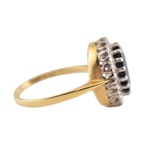 108 - An 18ct gold sapphire and diamond cluster ring. Stamped 18ct. Weight 3.9g. Size K