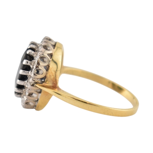 108 - An 18ct gold sapphire and diamond cluster ring. Stamped 18ct. Weight 3.9g. Size K