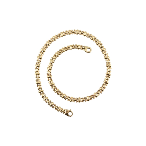 109 - A hallmarked 9ct gold fancy link chain necklace. The necklace is formed with fancy cross links to a ... 
