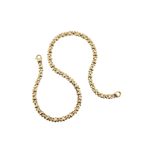 109 - A hallmarked 9ct gold fancy link chain necklace. The necklace is formed with fancy cross links to a ... 